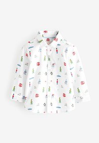 Chemise blanche à manches longues boutonnée avec des imprimés de dessins animés colorés de gardes, bus rouges, manchots, robots, dinosaures et voitures.