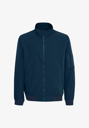 Karinių jūrų pajėgų bombonešių striukė su stovinčiu apykakle, priekiniais užtrauktukais, šoninėmis kišenėmis ir kišenėle su užtrauktuku ant rankovės. Lygus audinys su gumbelinėmis rankogaliais ir apačia.