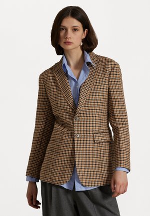 Brown check-patterned blazer made of textured fabric, featuring a single button closure, notch lapels, and two front pockets over a blue shirt.