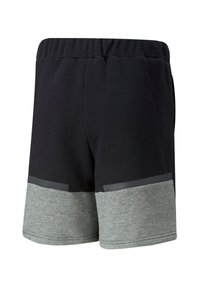 Puma TEAMCUP CASUALS - Pantaloni sportivi - schwarz