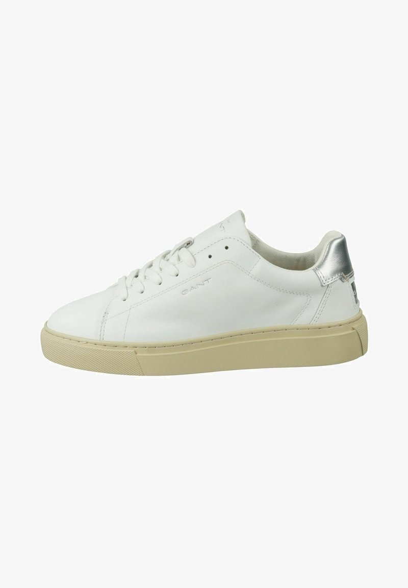 White leather sneaker with a textured cream sole, silver accent at the heel, rounded toe, and lace-up closure. Branding visible on the side.