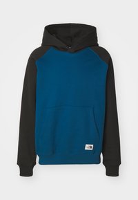 Felpa con cappuccio blu e nera, dotata di tasca a marsupio, polsini e orlo a coste. Presenta un'etichetta logo prominente sul fondo.