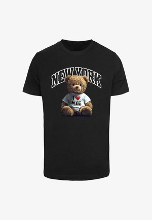 Black t-shirt featuring a graphic of a teddy bear wearing a white "I ♥ NYC" shirt, with "NEW YORK" text arched above.