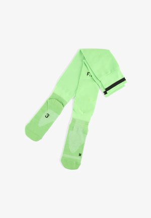 Chaussettes de sport vertes avec un dessus en maille texturée, semelle rembourrée et une bande noire au niveau de la cheville. Taille indiquée comme "3" au niveau de la semelle.