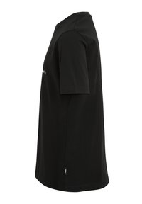 Camiseta de algodón negra con cuello redondo y mangas cortas. Presenta una pequeña etiqueta de logo en el dobladillo. Textura suave y ajuste estándar.