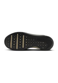 Black rubber shoe sole with textured pattern, featuring grooves and raised sections for traction, accented by tan horizontal stripes.