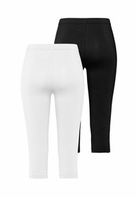 Leggings en coton blancs et noirs, dotés d'une taille élastique, d'une texture lisse et d'une longueur cropped. Conception simple sans motifs.