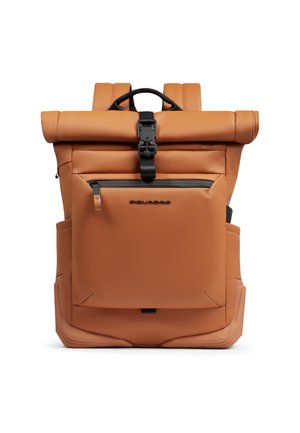 Tan roll-top backpack with a front zippered pocket, black buckle closure, side pockets, and padded shoulder straps.