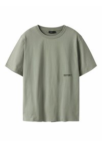 Green cotton t-shirt, relaxed fit, short sleeves, round neckline, featuring "REVERY." text in black on the left side near the hem.