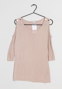 Ljusrosa kall axel-top med trekvartsärmar. Tillverkad av mjukt material, har rundad halsringning och två metallaccenter på axlarna.