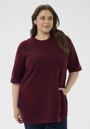 Burgunderfarbener Langarmpullover mit einer strukturierten, weichen Maschenware. Verfügt über seitliche Taschen und eine lockere Passform mit hochgerollten Ärmeln.