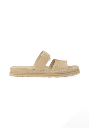 Sandalo beige in suede con due cinturini regolabili, dettagli cuciti e suola testurizzata per uso casual.