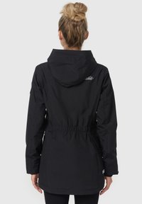 Black waterproof jacket with a hood, cinched waist, and elastic cuffs. Features a mountain logo on the upper back and smooth texture.