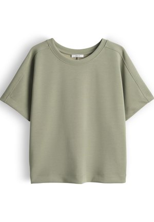 Lichtgroen katoenen T-shirt met korte mouwen, ronde hals en zichtbare stikseldetails, plat neerligt op een witte achtergrond.