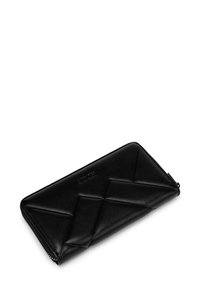 Black leather wallet with a quilted design, featuring a zip closure and embossed logo. Smooth texture and elongated rectangular shape.