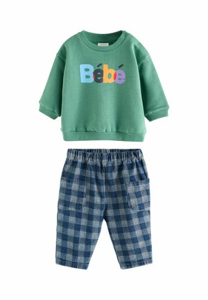 Green long-sleeve baby sweatshirt with "Bébé" in colorful letters paired with blue and gray checkered pants with front pockets.
