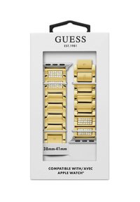 Bracelets en métal doré pour Apple Watch dans une boîte, avec des maillons lisses, des accents de rhinestones et une indication de compatibilité pour les montres de 38 mm à 41 mm.