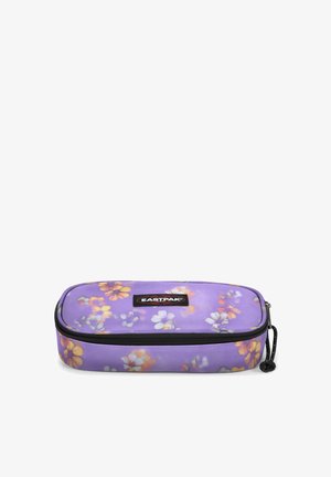 Purple pencil case with floral print in yellow, white, and pink. Features a zip closure and a branded black label on the front.