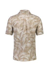 Chemise à manches courtes avec un fond beige, ornée de motifs de feuilles tropicales blanches. Fabriquée dans un tissu léger et texturé.