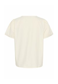Top a maniche corte di colore crema con una vestibilità rilassata, caratterizzato da maniche a sbuffo e una texture liscia e morbida. Senza hardware o motivi visibili.