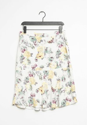 White skirt with yellow, green, and burgundy floral pattern hanging on black hanger against white background.