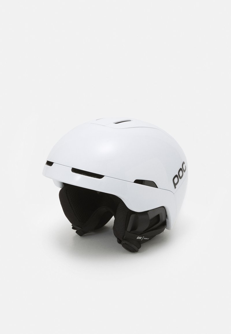 Casque de ski blanc avec un design lisse et arrondi, rembourrage intérieur noir et sangle de menton réglable. Présente des fentes de ventilation sur le dessus.