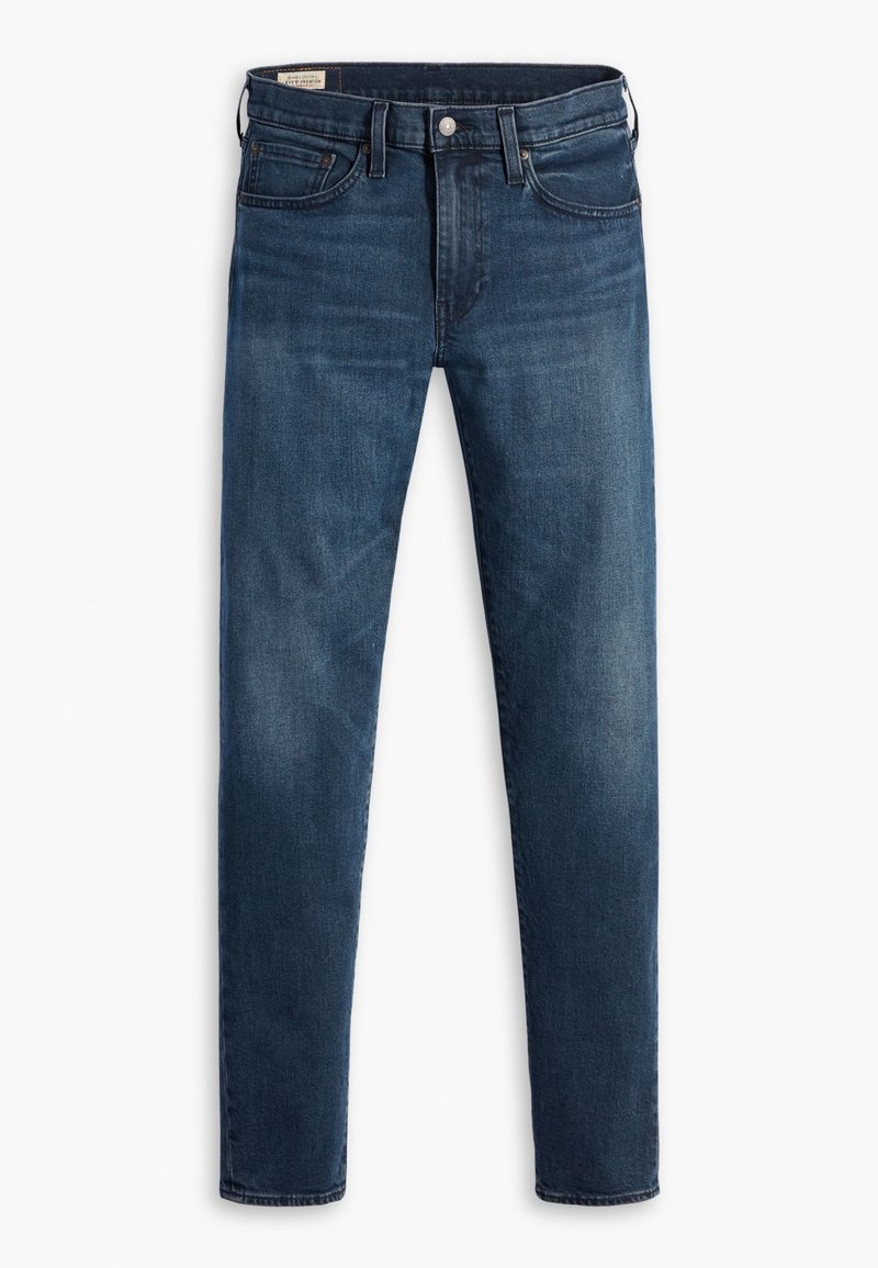 Jean en denim bleu foncé à coupe slim, doté de cinq poches, d'un zip à bouton et de légères décolorations sur les jambes.