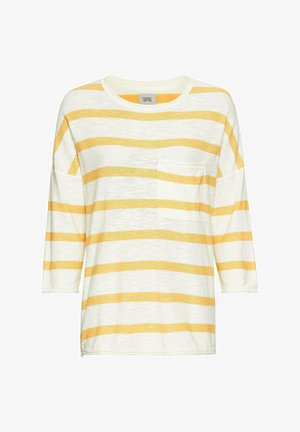 Striped long-sleeve shirt in white and yellow. Features a front pocket, round neckline, and loose fit. Made from lightweight fabric.
