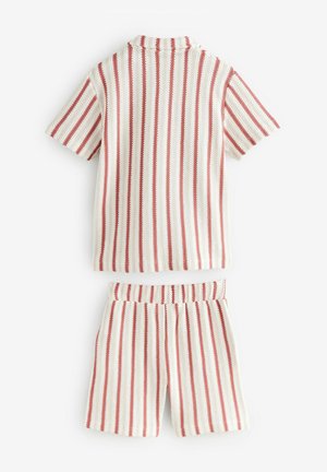 Knitted two-piece outfit with short sleeves and shorts. White base with vertical red stripes. Features a collared neck and elastic waistband.