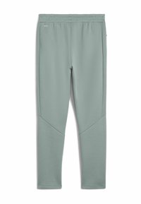 Lys grønne sportbukser lavet af glat stof. Har elastisk linning, smalle ben og trekantede dekorative paneler nær knæene.