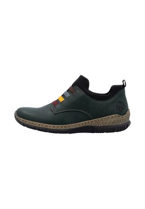 Bottine slip-on vert foncé avec des bandes élastiques multicolores, un col rembourré noir, une semelle intermédiaire texturée marron et une semelle extérieure en caoutchouc noir.