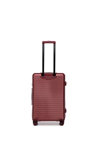 Hard-shell suitcase in metallic burgundy with vertical ribbed texture, retractable black handle, four wheels, and side handles for easy lifting.