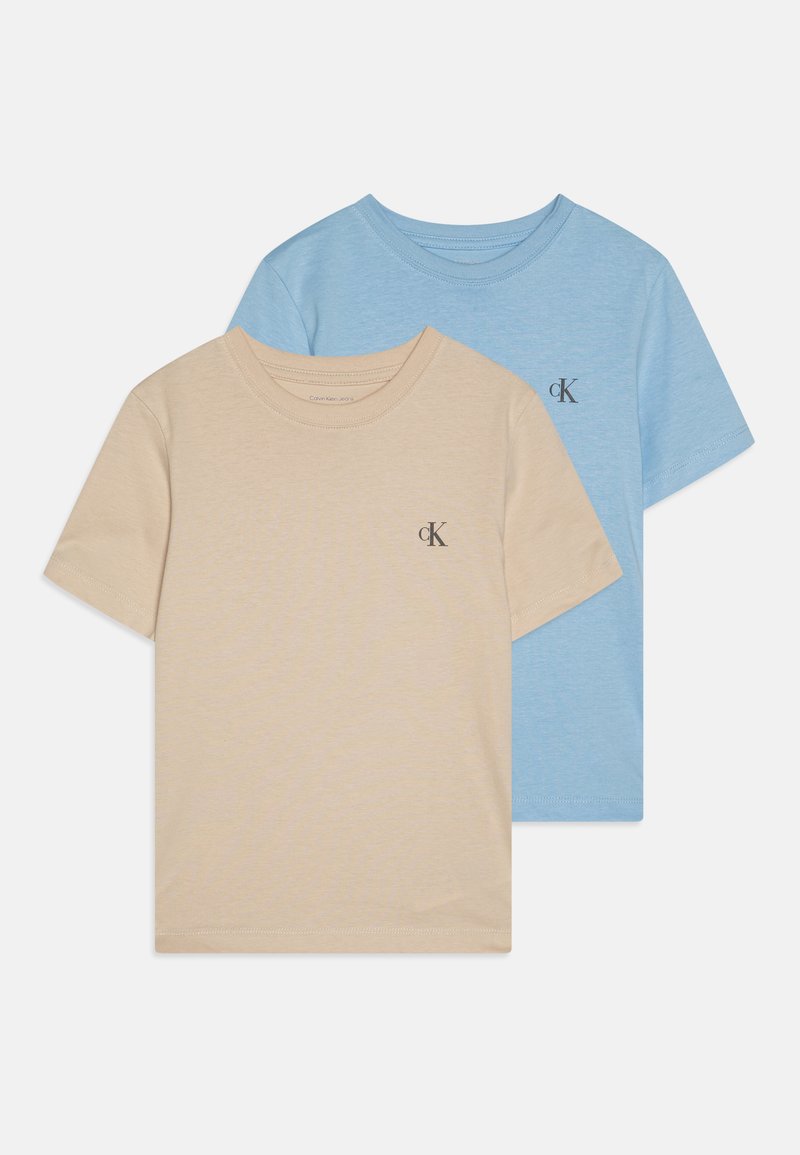 Divas īsām piedurknēm T-krekli: viens bēšs un otrs gaiši zils. Abiem ir apaļas izgrieznes un mazs "ck" logo uz krūtīm. Mīksts kokvilnas materiāls.