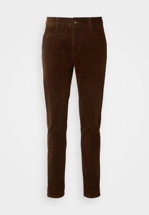 Bruine corduroy broek met een rechte pijpdesign, voorzien van een knoopsluiting en subtiele verticale ribbelstructuur.