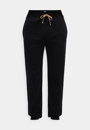 Pantaloni jogger negri din material moale, cu un tiv elastic și un șnur bej, având buzunare laterale. Design minimal.