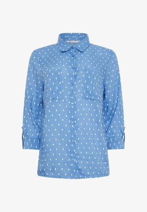 Camisa de botones azul claro con patrones rectangulares blancos, mangas largas, dos bolsillos en el pecho y un cuello redondeado.
