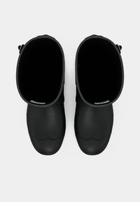 Μαύρες καουτσούκ μπότες μέχρι τον αστράγαλο με στρογγυλή μύτη, ομαλή ματ επιφάνεια και ανοιχτή κορυφή. Διαθέτουν αδιάσπαστο σχέδιο χωρίς ορατό υλικό.