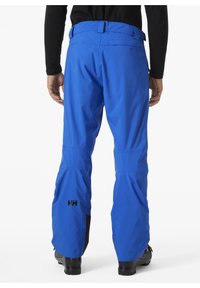 Modré nepromokavé lyžařské kalhoty vyrobené z lehkého materiálu, s hladkým povrchem, nastavitelným pasem a subtilním logem na noze.