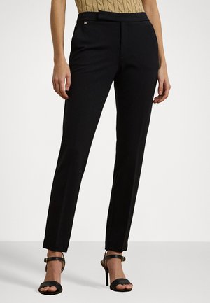 Black tailored trousers in stretch fabric, featuring a straight leg design and a smooth waistband with a small brand logo detail.