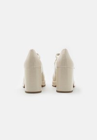 Marco Tozzi Platform magas sarkúk - cream