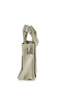 Beige crossbody bag with textured fabric, black trim, and detachable strap, shown from side on white background.