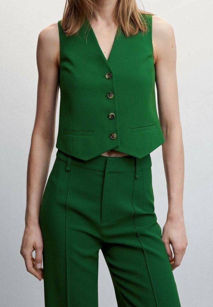 Green tailored vest with a V-neck, five wooden buttons, and two front pockets, paired with matching high-waisted trousers.