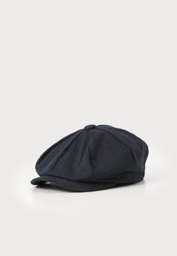Dark blue linen cap with a rounded top, multiple darts, and a short brim. The texture appears slightly woven and soft.