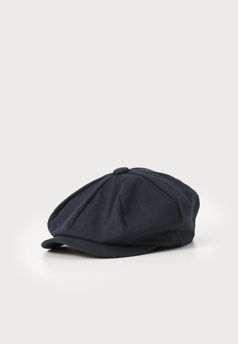 Dark blue linen cap with a rounded top, multiple darts, and a short brim. The texture appears slightly woven and soft.