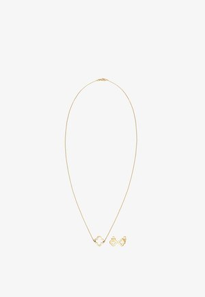 Guld-tone halskæde med en central kløverformet vedhæng, parret med matchende kløvere øreringe. Glat finish, minimalistisk design.