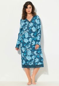 Camicetta floreale in teal e azzurro chiaro, con maniche lunghe, scollatura a V e pizzo sul bordo. Tessuto morbido con motivo floreale.