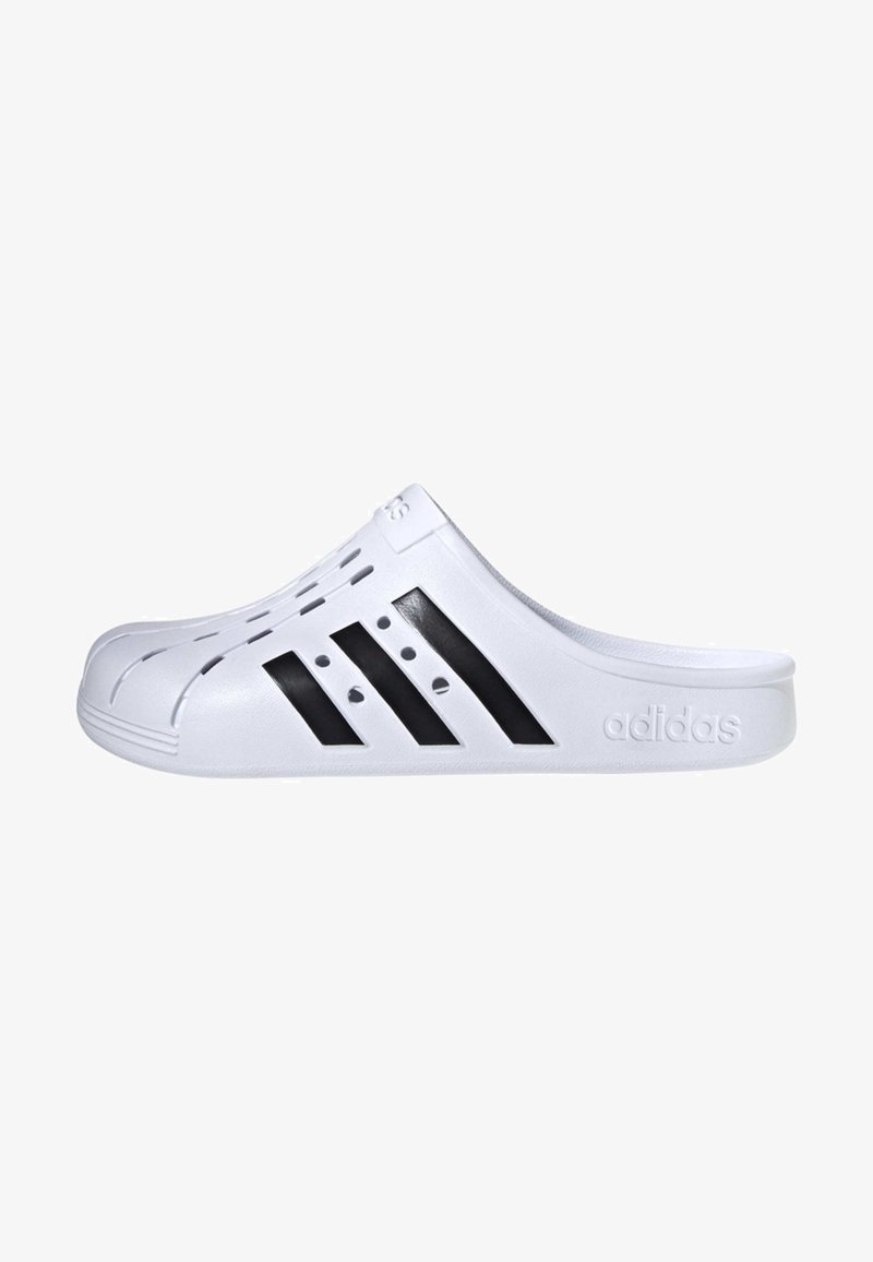 White slip-on clog with black three-stripe design, vent holes along the top, and textured detailing on the sole. "Adidas" logo on the side.