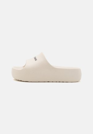 White slide sandal made of smooth material, featuring a rounded open toe design and a textured sole with a subtle logo detail.