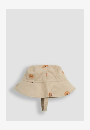 Neitrānas krāsas auduma bukletu cepure ar plašu maliņu. Izcelti krāsaini izšūti lauvas sejas akcenti. Iekļauta regulējama zoda siksniņa.