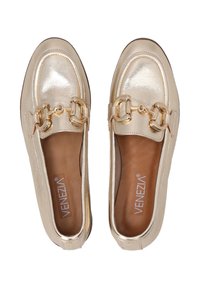 Gold metallic loafers feature a smooth finish with a round toe, decorative gold chain hardware, and a brown leather insole with branding.